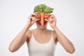 Young blonde woman holding vegetables like it is her face. Royalty Free Stock Photo