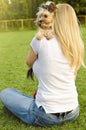 Young blonde woman hugging her cute Yorkshire terrier Royalty Free Stock Photo