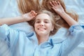 Young woman at home laying in bed woke up top view hands up playful Royalty Free Stock Photo