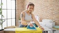 Young blonde woman listening to music ironing clothes at laundry room Royalty Free Stock Photo