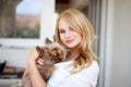 Young blonde woman with little dog Royalty Free Stock Photo