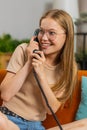 Woman making wired old-fashioned retro vintage telephone talking conversation with friends at home Royalty Free Stock Photo