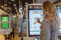 Young blonde woman in McDonald`s makes an order online. Moscow, Russia, 09/21/2020