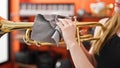 Young blonde woman musician cleaning trumpet at music studio Royalty Free Stock Photo