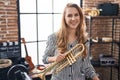 Young blonde woman musician holding trumpet at music studio Royalty Free Stock Photo