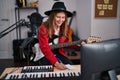 Young blonde woman musician playing electrical guitar composing song at music studio Royalty Free Stock Photo