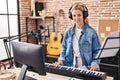 Young blonde woman musician playing piano keyboard at music studio Royalty Free Stock Photo