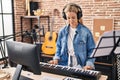 Young blonde woman musician playing piano keyboard at music studio Royalty Free Stock Photo