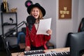 Young blonde woman musician smiling confident singing song at music studio