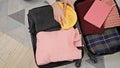 Young blonde woman packing clothes on suitcase for journey at home Royalty Free Stock Photo