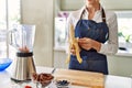 Young blonde woman peeling banana at kitchen Royalty Free Stock Photo