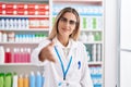 Young blonde woman pharmacist smiling confident shake hand at pharmacy Royalty Free Stock Photo