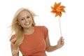 Young blonde woman with pinwheel smiling Royalty Free Stock Photo