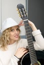 Young blonde woman playing the acoustic guitar Royalty Free Stock Photo