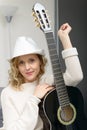 Young blonde woman playing the acoustic guitar Royalty Free Stock Photo