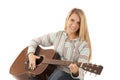 Young blonde woman playing acoustic guitar Royalty Free Stock Photo