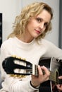 Young blonde woman playing guitar Royalty Free Stock Photo