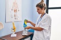 Young blonde woman podiatrist holding insole at clinic