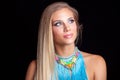 Young blonde woman portrait with large blue necklace Royalty Free Stock Photo