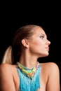 Young blonde woman portrait with large blue necklace Royalty Free Stock Photo