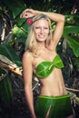 Young blonde woman posing with banana leaves Royalty Free Stock Photo