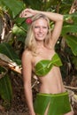 Young blonde woman posing with banana leaves Royalty Free Stock Photo