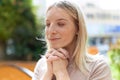 Young blonde woman praying with closed eyes at park Royalty Free Stock Photo