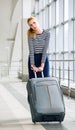 Young blonde woman pulling heavy suitcase on the station was going on a trip. It is difficult to carry luggage. Tired Royalty Free Stock Photo