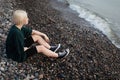 Young blonde woman relaxing near sea outdoors Royalty Free Stock Photo