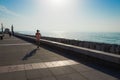 A young woman runs along the sea