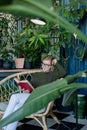 Young blonde woman sitting in comfortable chair reading a book Royalty Free Stock Photo