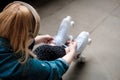 Young blonde woman sitting on the floor tying shoe laces on her roller skate Royalty Free Stock Photo