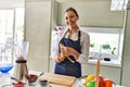 Young blonde woman smiling confident peeling banana at kitchen Royalty Free Stock Photo