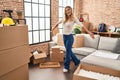 Young blonde woman smiling confident standing with open arms at new home Royalty Free Stock Photo