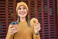 Young blonde woman smiling happy having breakfast at the city