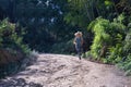 Young blonde woman in sportswear running cross-country through the mountains on a nature trail. Concept, running, trailrunning, Royalty Free Stock Photo