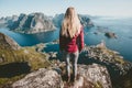 Young blonde woman standing alone on cliff mountain Royalty Free Stock Photo