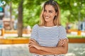 Young blonde woman standing with arms crossed gesture at park Royalty Free Stock Photo