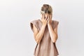 Young blonde woman standing over isolated background with sad expression covering face with hands while crying Royalty Free Stock Photo