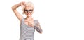 Young blonde woman with tattoo wearing casual clothes and glasses smiling making frame with hands and fingers with happy face Royalty Free Stock Photo