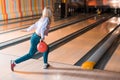 Young blonde woman throwing bowling ball Royalty Free Stock Photo