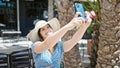 Young blonde woman tourist smiling confident make selfie by smartphone at coffee shop terrace Royalty Free Stock Photo