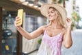 Young blonde woman tourist smiling confident make selfie by smartphone at coffee shop terrace Royalty Free Stock Photo