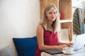 Young blonde woman typing in laptop in cafe Royalty Free Stock Photo