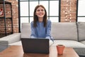 Young blonde woman using laptop sitting on sofa at home Royalty Free Stock Photo