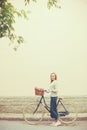Young blonde woman on a vintage bicycle Royalty Free Stock Photo