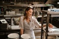 Young woman holding order receipts while working in restaurant kitchen Royalty Free Stock Photo