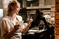 Young woman holding order receipts while working in restaurant kitchen Royalty Free Stock Photo