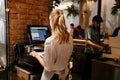 Young woman holding order receipts while working in restaurant kitchen Royalty Free Stock Photo