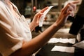 Young woman holding order receipts while working in restaurant kitchen Royalty Free Stock Photo